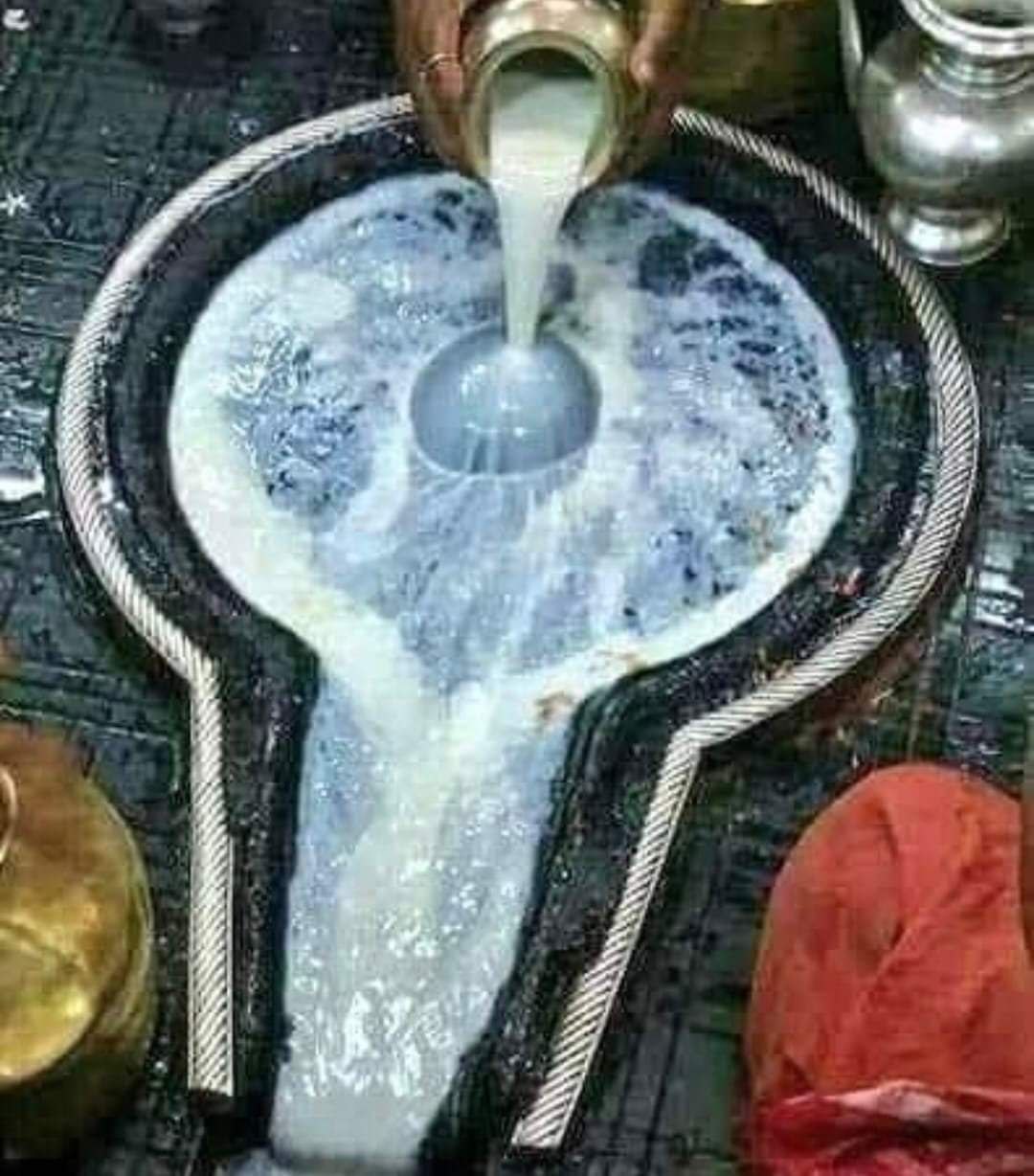 Milk being poured on the shivling during Dugdh Abhishekam