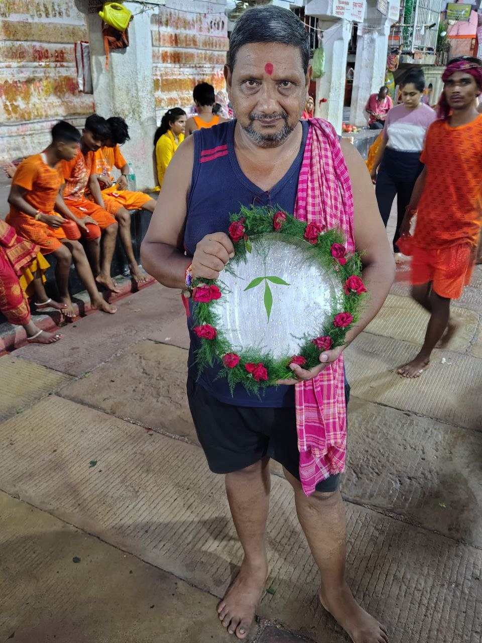 Devotee with a decorated offering thali at the temple