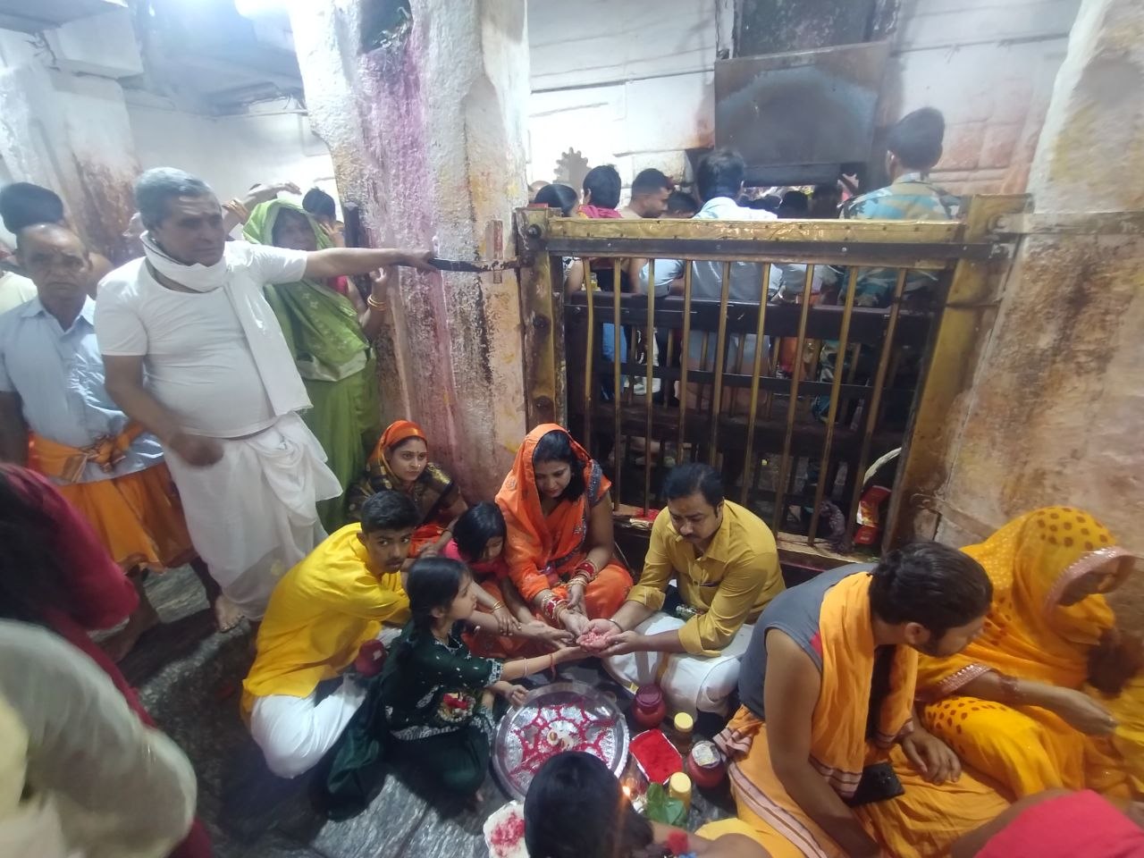 A family performing their sankalp puja at the garbha griha