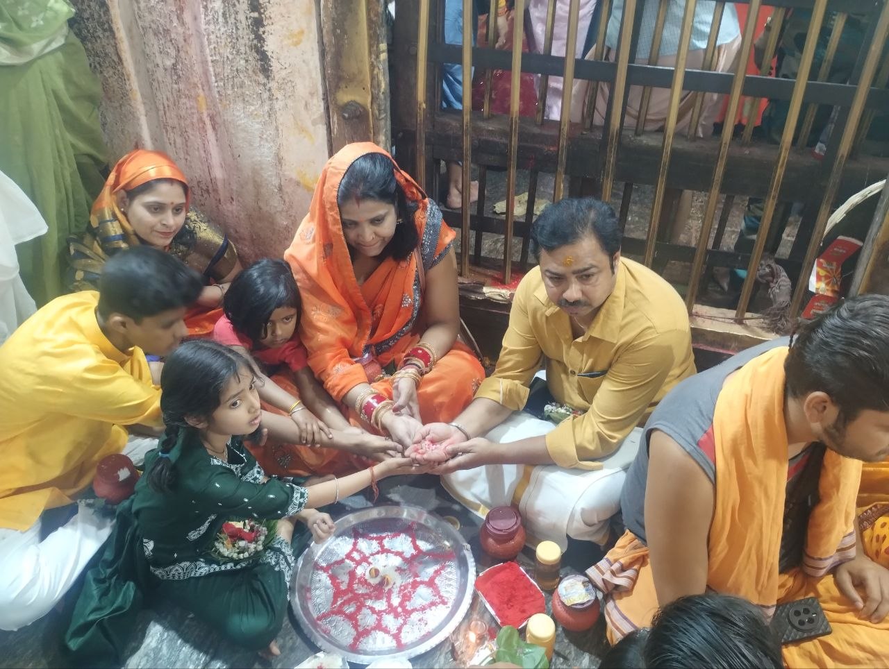 A family offering their sankalp together at the temple